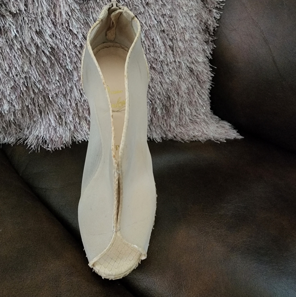 Size 6.5/ 36.5 Red Bottoms. Tan and mesh snake skin.